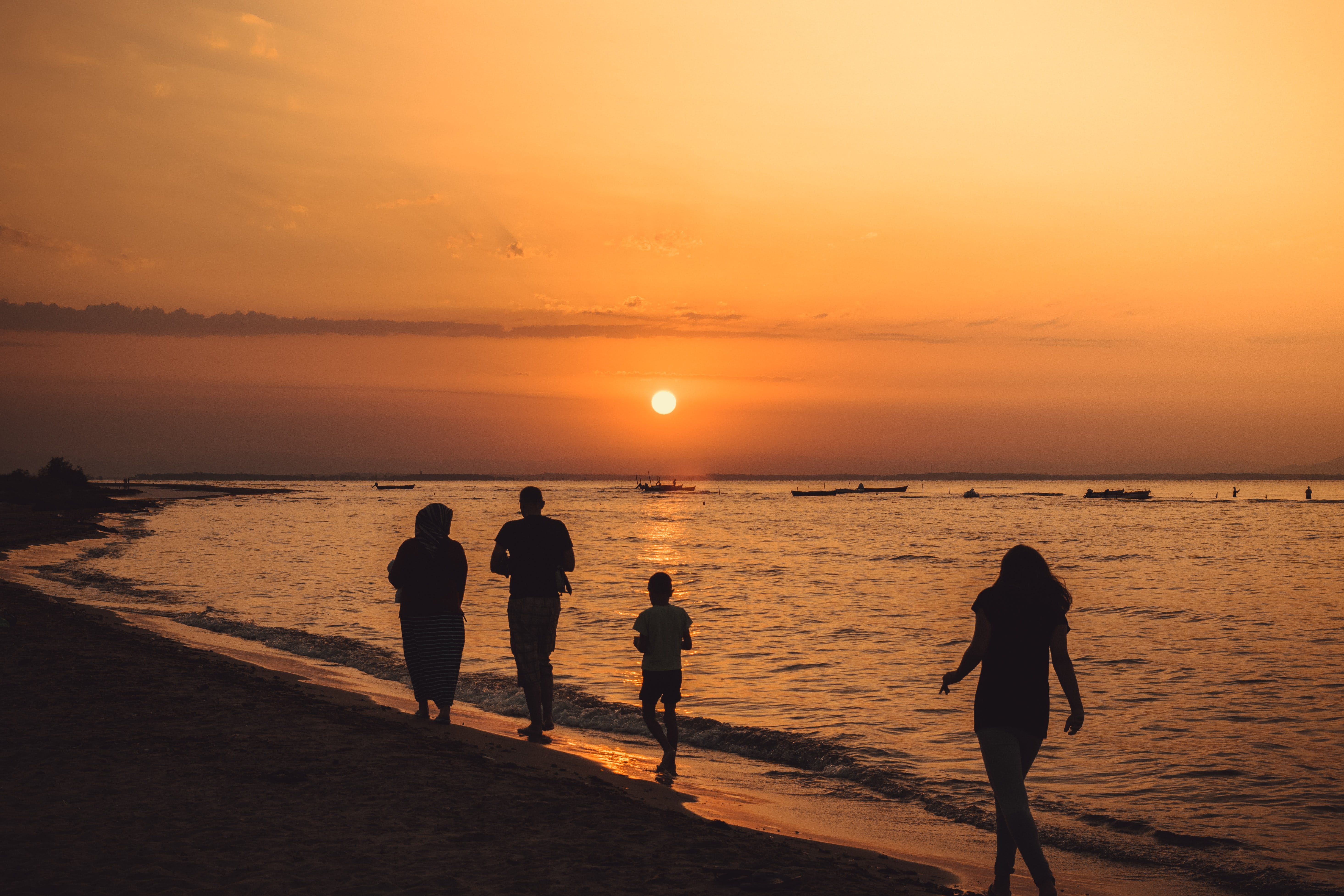 family walking along the shoreline